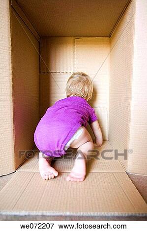 Stock Photo - baby, back view, barefoot, blond, cardboard. Fotosearch