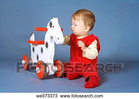 Baby boy playing with toy View Large Photo Image Stock Image - Baby boy playing with toy. Fotosearch