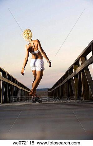 Stock Photo - back, balance, back view, 20's. Fotosearch