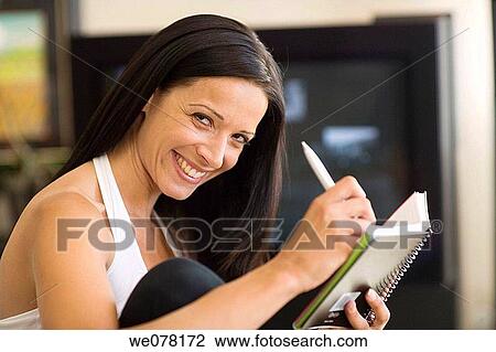 Ball-point pen, brunette, concentrated View Large Photo Image Stock Image - Ball-point pen, brunette, concentrated. Fotosearch