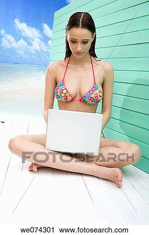 Stock Image - barefoot, beach, brunette. Fotosearch