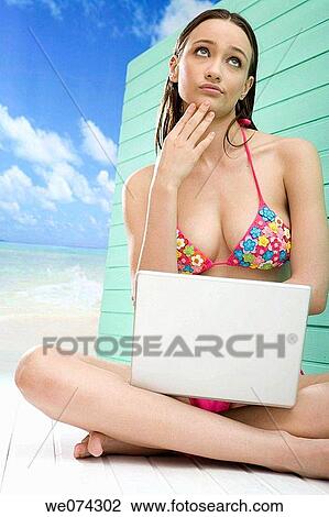 Stock Image - barefoot, beach, brunette. Fotosearch