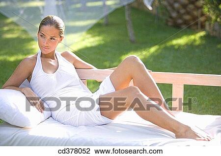 Stock Image - barefoot, calm, brunette, absorbed. Fotosearch