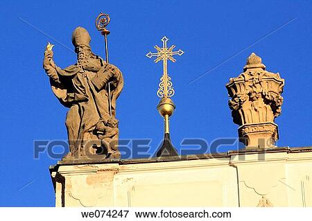 Baroque sculpture by Johann Anton Quitanainer of a Bishop ornaments the roof of the Church of the Assumption in Strahov Monastery. Czech Republic View Large Photo Image Stock Photo - Baroque sculpture by Johann Anton Quitanainer of a Bishop ornaments the roof of the Church of the Assumption in Strahov Monastery. Czech Republic. Fotosearch