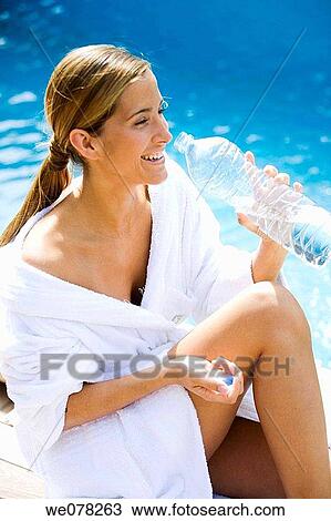 Stock Image - bathrobe, beauty, border, bottle, brown hair. Fotosearch