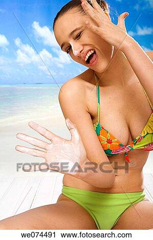 beach, Body care, brunette View Large Photo Image Stock Image - beach, Body care, brunette. Fotosearch