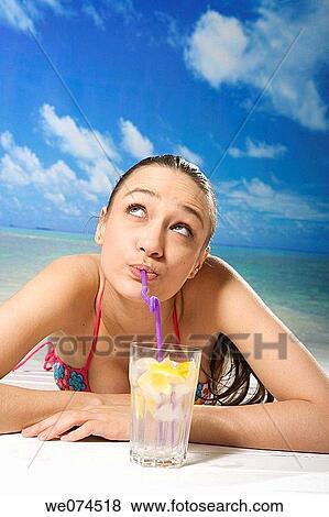 Stock Photo - beach, brunette, absorbed. Fotosearch