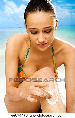 Stock Image - beach, brunette, Body care, apply. Fotosearch