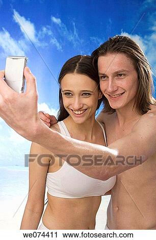 Stock Image - beach, camera, cell phone. Fotosearch