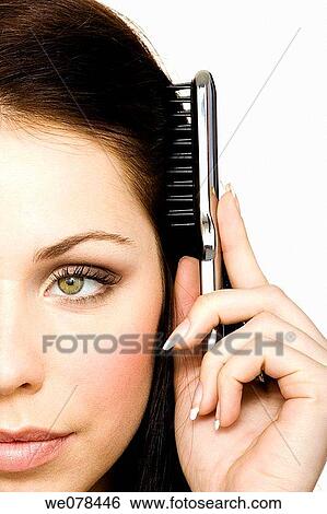 Stock Photograph - beauty, Beauty Care, brunette, brush, Brushing hair. Fotosearch