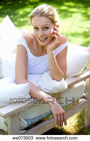 Stock Image - beauty, calm, blond, armchair. Fotosearch