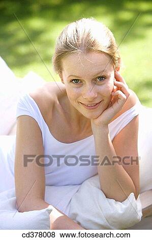 Stock Photo - beauty, calm, blond, armchair. Fotosearch