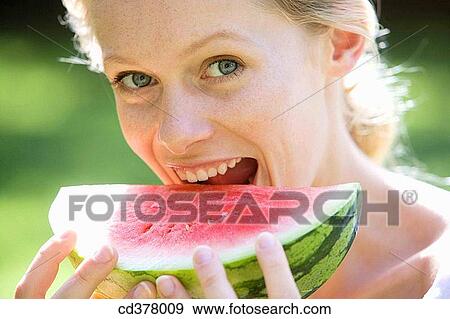 Stock Photo - bite, biting, blond, Close-up. Fotosearch