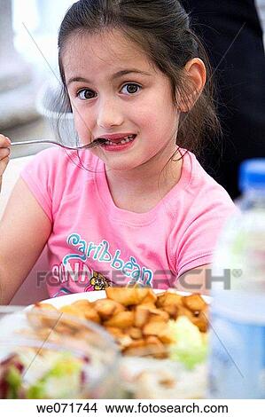 Picture - bite, biting, brunette, child, childhood. Fotosearch