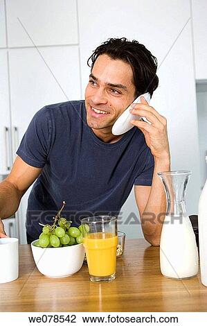 Stock Image - black hair, calling, breakfast, at-home. Fotosearch