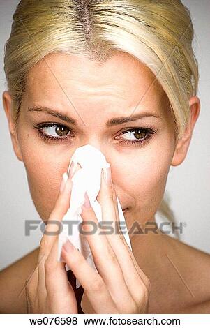 Stock Photo - blond, Blowing nose, Blow nose, allergy. Fotosearch