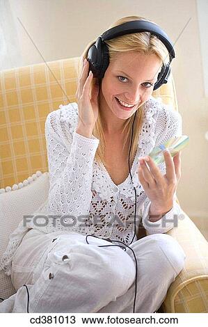 Stock Image - blond, cds, CD, at-home. Fotosearch