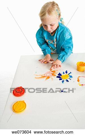Blond girl is fingerpainting View Large Photo Image Picture - Blond girl is fingerpainting. Fotosearch