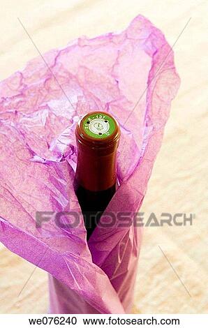 Bottle of wine wrapped in paper View Large Photo Image Stock Image - Bottle of wine wrapped in paper. Fotosearch