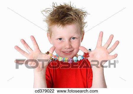 Boy showing a necklace View Large Photo Image Stock Image - Boy showing a necklace. Fotosearch