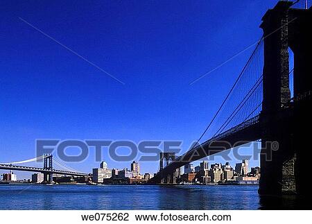 Stock Image - BROOKLYN AND MANHATTAN. BRIDGES BROOKLYN SKYLINE NEW YORK. USA. Fotosearch