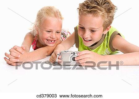 Brother and sister looking at photos in the camera View Large Photo Image Stock Image - Brother and sister looking at photos in the camera. Fotosearch