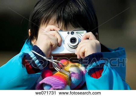 Stock Image - brunette, camera, child, Close-up. Fotosearch