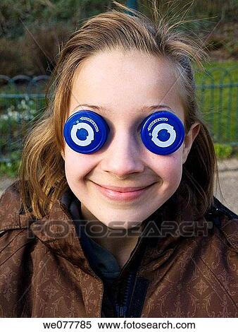 Stock Photography - Child with bottle top eyes. Fotosearch
