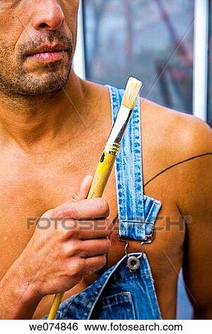 Close-up of a man holding an artist's paintbrush. View Large Photo Image Stock Photograph - Close-up of a man holding an artist's paintbrush.. Fotosearch