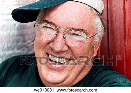 Close-up of a middle-age man wearing glasses and a hat. View Large Photo Image Stock Image - Close-up of a middle-age man wearing glasses and a hat.. Fotosearch