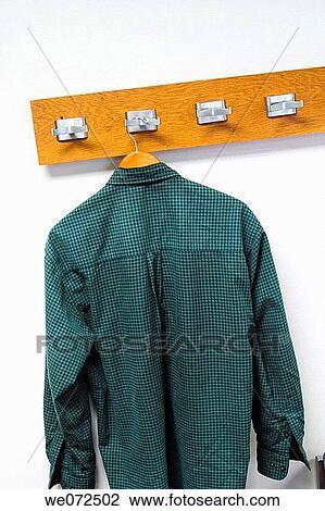 Stock Image - Coatrack with a shirt hanging from it.. Fotosearch