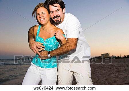 Couple at the beach at dusk Deerfield Beach, Florida, USA View Large Photo Image Picture - Couple at the beach at dusk Deerfield Beach, Florida, USA. Fotosearch