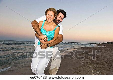 Couple at the beach at dusk, Deerfield Beach, Florida, USA View Large Photo Image Stock Image - Couple at the beach at dusk, Deerfield Beach, Florida, USA. Fotosearch