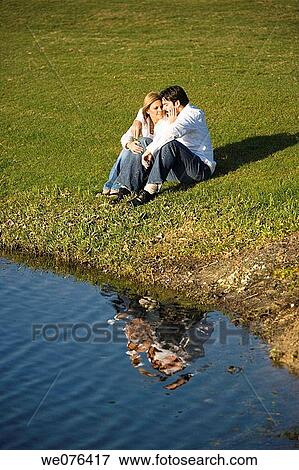 Couple sitting by a lake, Deerfield Beach, Florida, USA View Large Photo Image Stock Photo - Couple sitting by a lake, Deerfield Beach, Florida, USA. Fotosearch