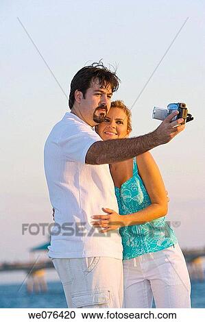 Couple with video camera at the beach, Deerfield Beach, Florida, USA View Large Photo Image Stock Image - Couple with video camera at the beach, Deerfield Beach, Florida, USA. Fotosearch