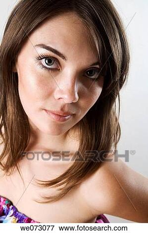 Stock Photo - Early 20's caucasian female strikes a sexy pose in studio portrait.. Fotosearch