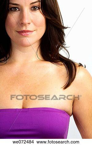 Picture - Face and upper body of young brunette woman in purple bikini in studio portrait.. Fotosearch