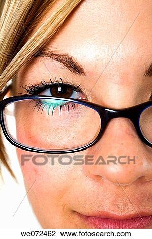 Facial closeup of eye and glasses of young blond woman with hair pulled back. View Large Photo Image Stock Image - Facial closeup of eye and glasses of young blond woman with hair pulled back.. Fotosearch