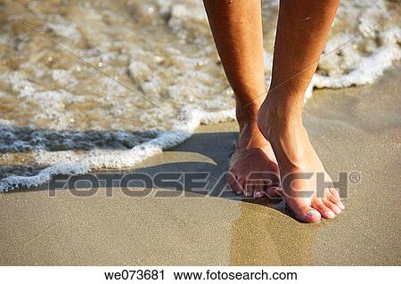 Feet walking on the beach View Large Photo Image Stock Image - Feet walking on the beach. Fotosearch