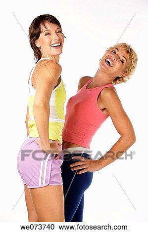 Fit mother and daughter pose in a studio setting View Large Photo Image Stock Image - Fit mother and daughter pose in a studio setting. Fotosearch