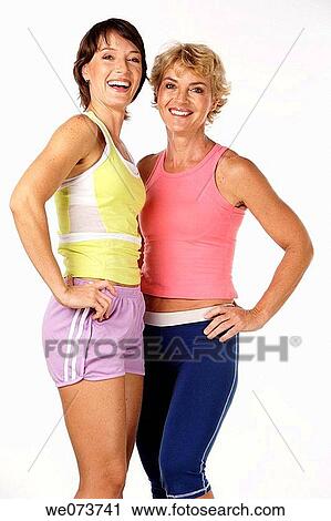 Fit mother and daughter pose in a studio setting View Large Photo Image Stock Image - Fit mother and daughter pose in a studio setting. Fotosearch