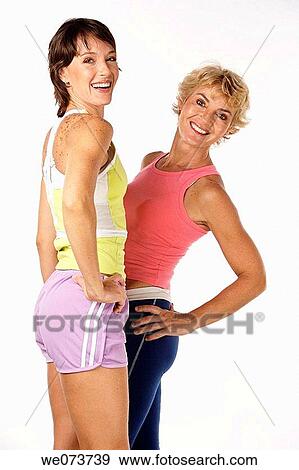 Fit mother and daughter pose in a studio setting View Large Photo Image Stock Photo - Fit mother and daughter pose in a studio setting. Fotosearch