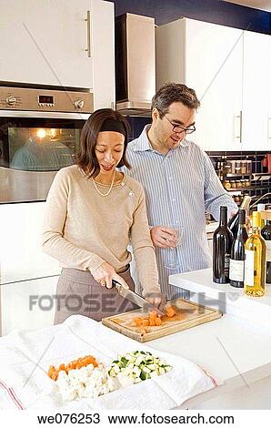 Stock Image - France, Paris, mix asian and euro couple cooking. Fotosearch