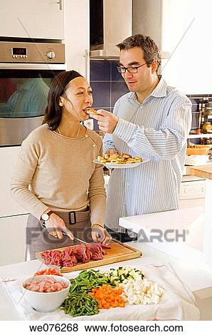 France, Paris, mix asian and euro couple cooking View Large Photo Image Stock Photo - France, Paris, mix asian and euro couple cooking. Fotosearch