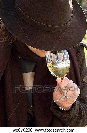Friends at a winetasting, holding white wine View Large Photo Image Stock Image - Friends at a winetasting, holding white wine. Fotosearch