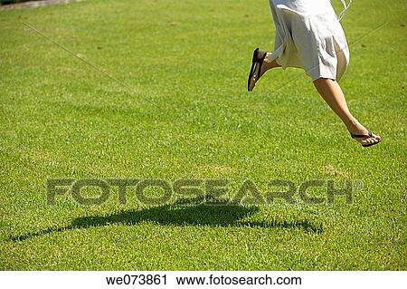 Girl jumping on the grass View Large Photo Image Stock Image - Girl jumping on the grass. Fotosearch