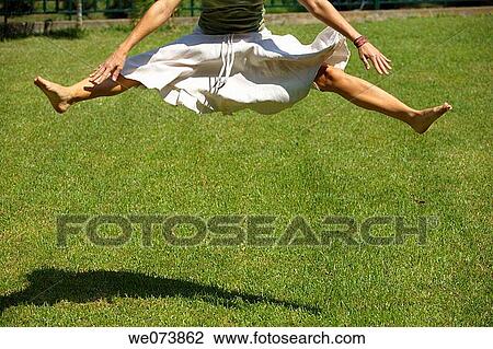 Girl jumping on the grass View Large Photo Image Stock Image - Girl jumping on the grass. Fotosearch