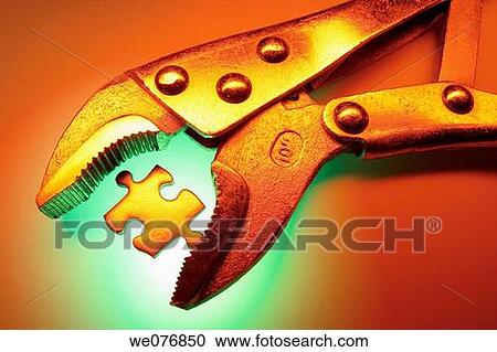 Stock Image - Gripping Plier with Jigaw Puzzle Piece. Fotosearch