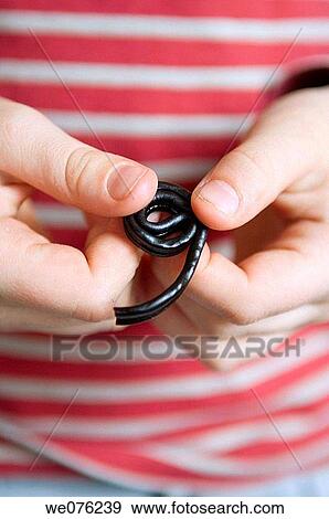 Kid holding licorice View Large Photo Image Stock Photo - Kid holding licorice. Fotosearch