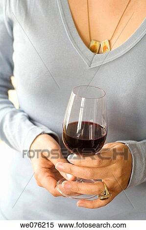 Lady drinking, smelling and looking at a glass of red wine View Large Photo Image Stock Photography - Lady drinking, smelling and looking at a glass of red wine. Fotosearch